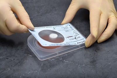 Ensure tension across the label and reattach it to the device