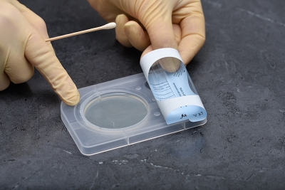 Roll the outer label back so that it adheres to itself